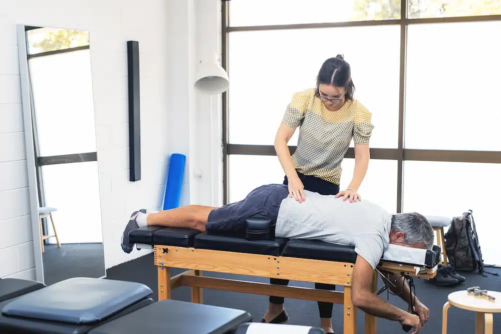 Old man having a lower back chiropractic